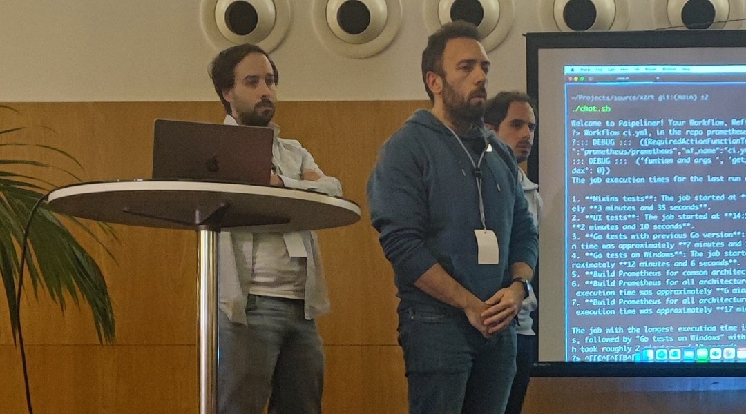 A photo of the 3 members of team xzrt presenting their project on the geekathon stage